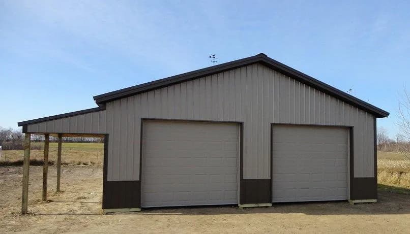 Burnished slate pole shed with small eave lean-to
