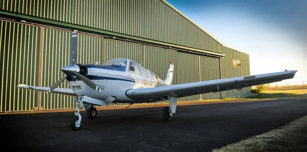 White post-frame aircraft hangar by Sherman Buildings